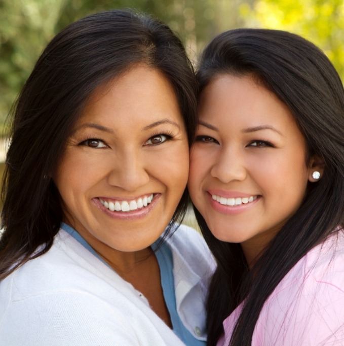 Two women hugging and smiling