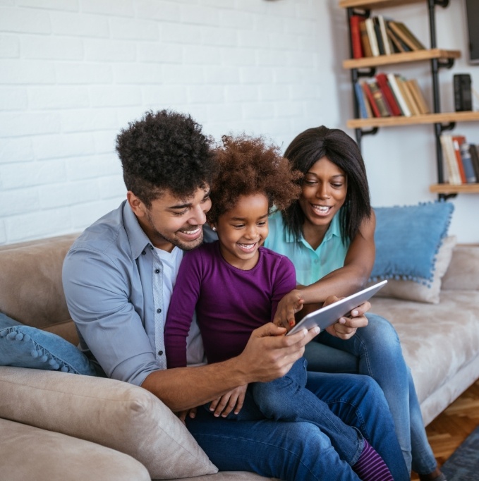 Parents showing child a tablet