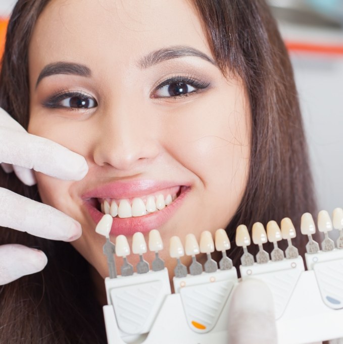 Shade matching womans smile for veneers