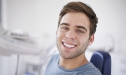 Man sitting in dental chair and smiling