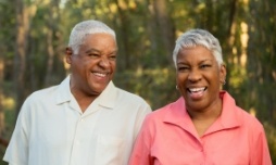 Senior couple standing outside and smiling