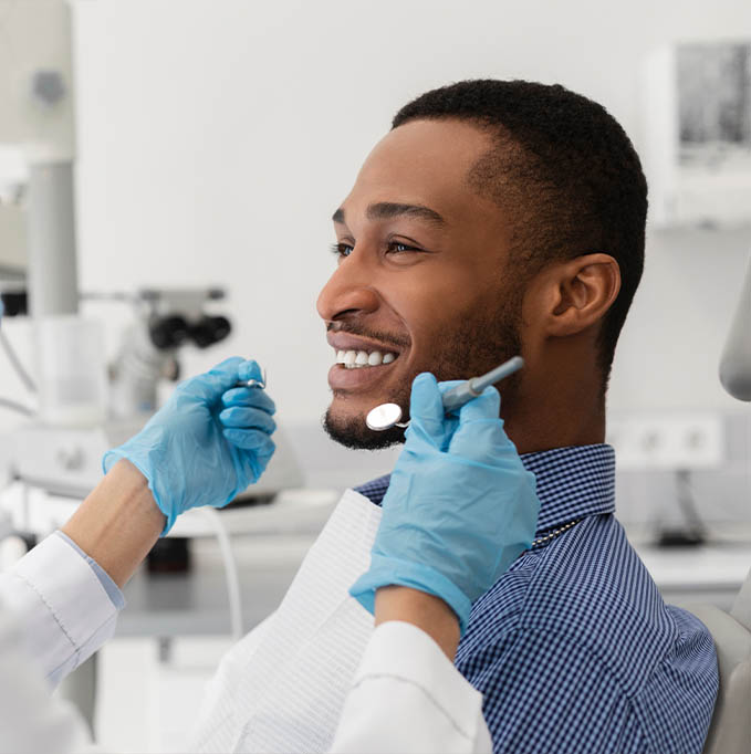 Male dental patient smiling during examination