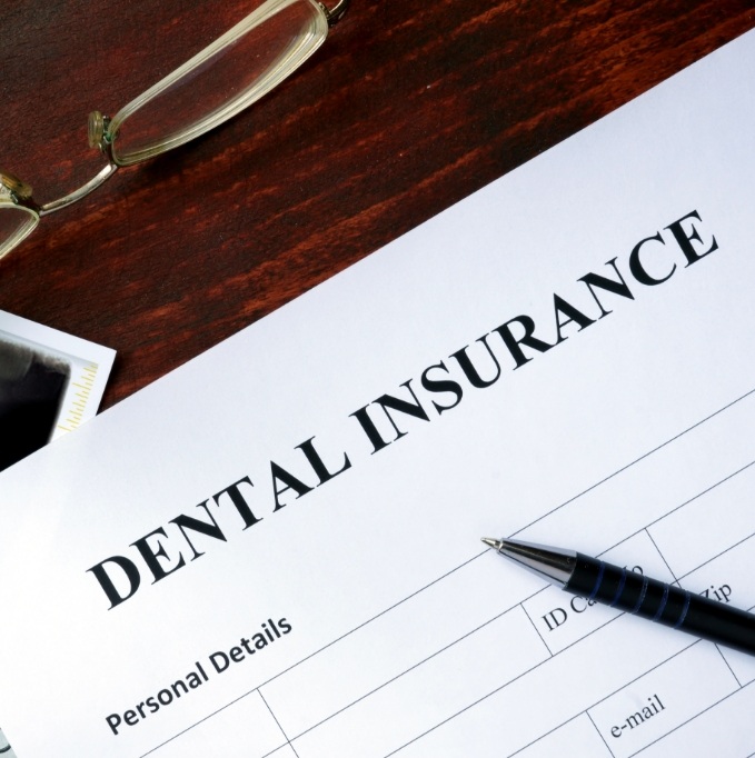 Dental insurance form on a wooden table