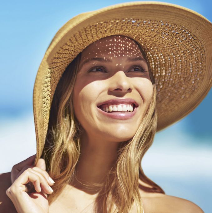 Woman in a straw hat smiling