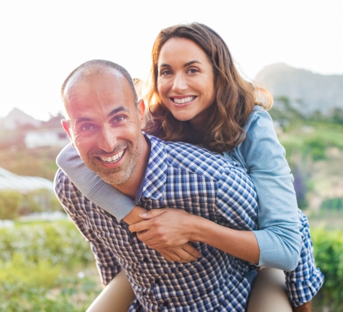 Man giving woman a piggyback ride