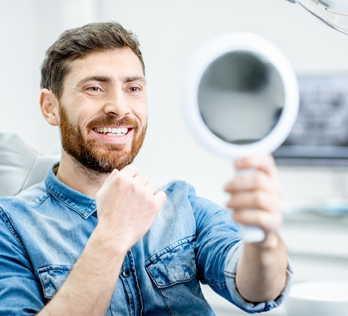 Man smiling at refection in mirror