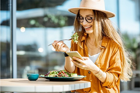 Smiling woman enjoying lunch outside