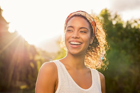 Woman smiling while walking outside